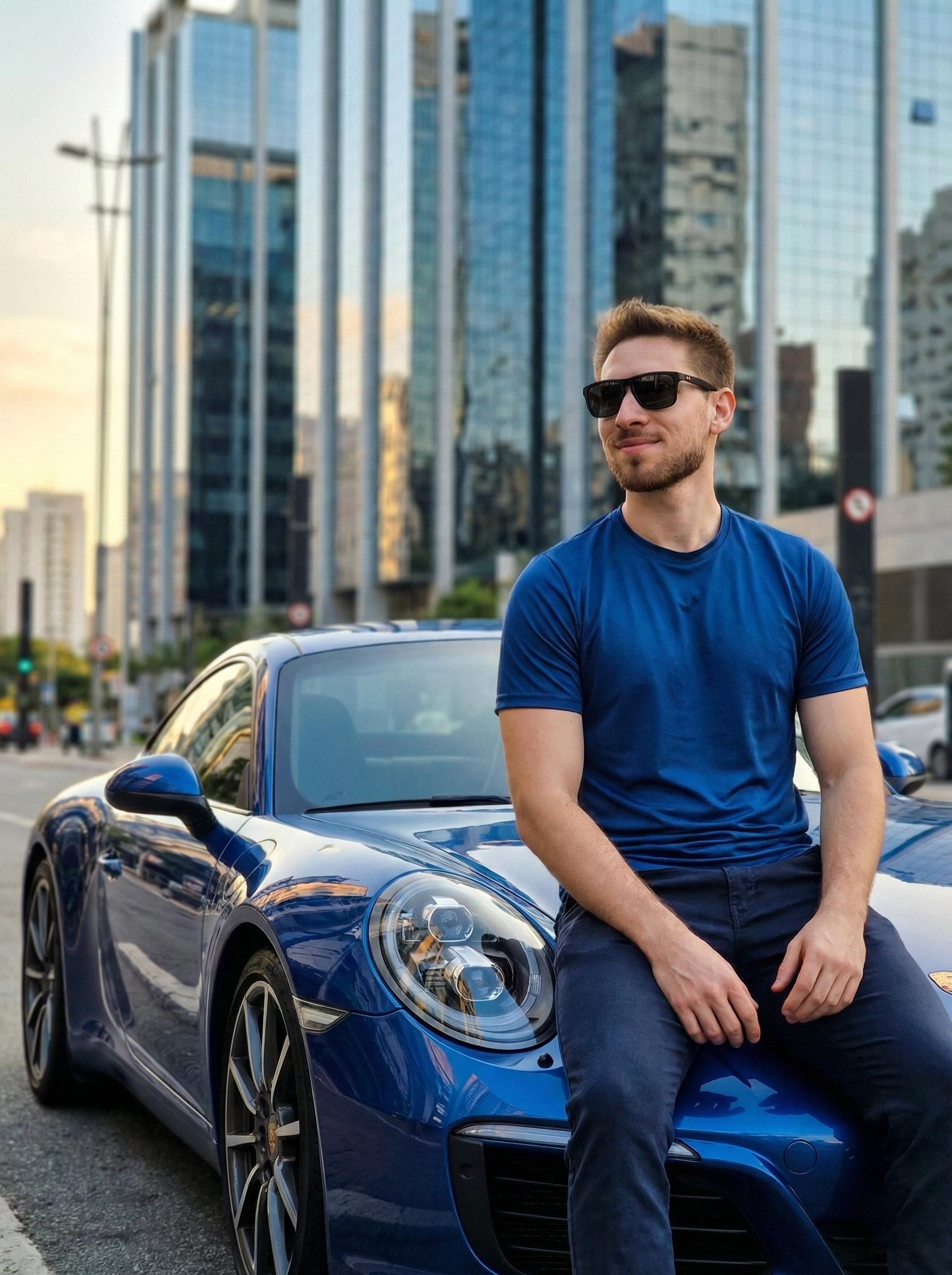 Homem na cidade em seu Porsche Azul